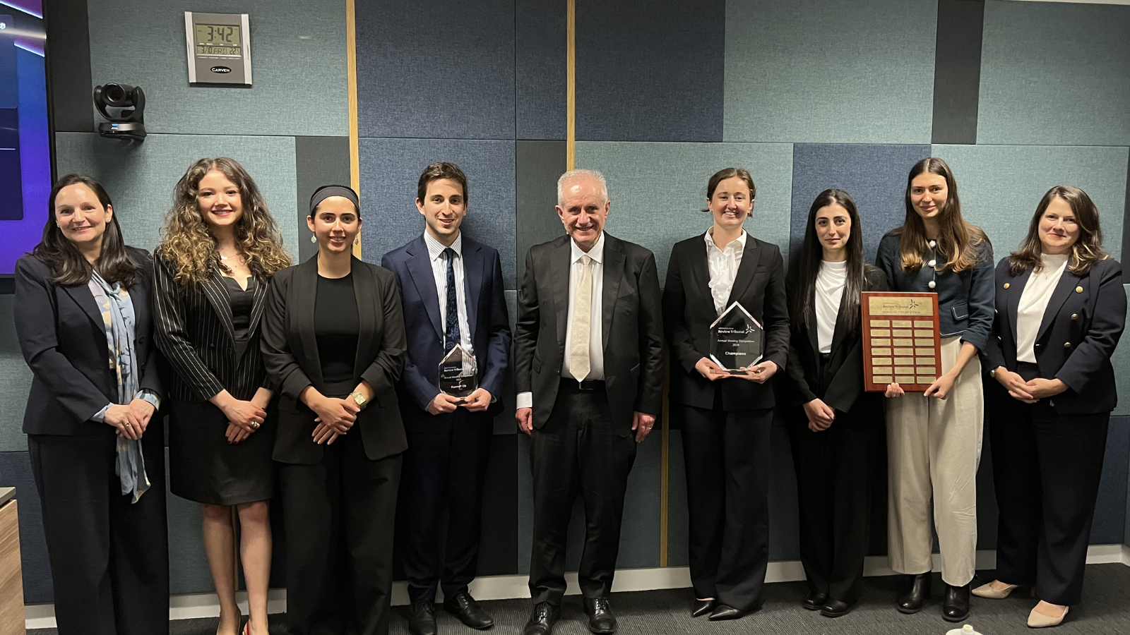Justice Kyrou, pictured 5th from left, with his fellow adjudicators (far left and far right) and both teams who competed in the grand final.